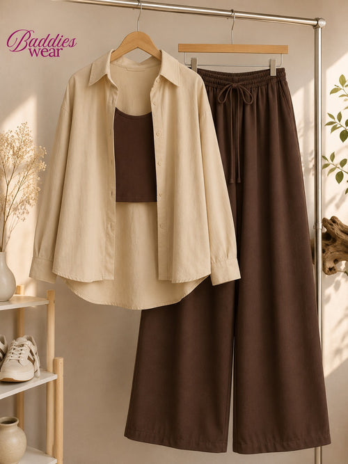A beige button-up shirt layered over a dark brown camisole, displayed alongside matching dark brown wide-leg drawstring pants on a clothing rack. The brand name 'Baddies wear' is visible in the top left corner.